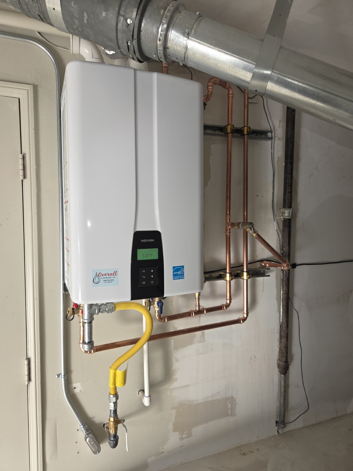Completed Navien tankless water heater installation with copper piping