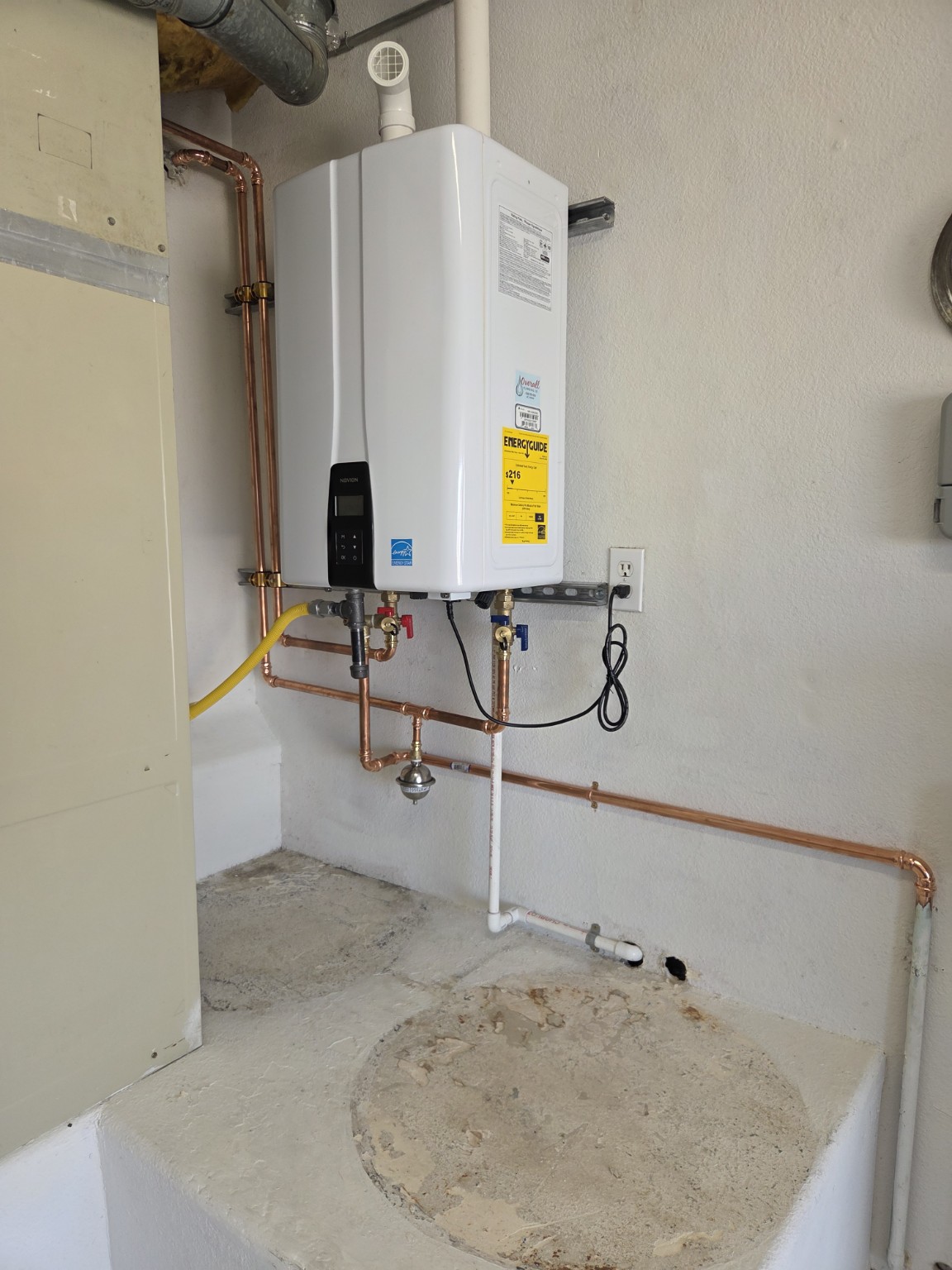 Completed wall-mounted Navien tankless water heater installation